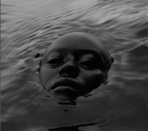 Face partially submerged in calm water