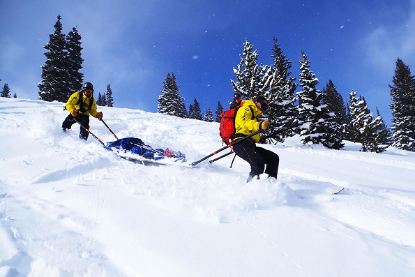 Ski patrol team working with limited staffing and equipment.